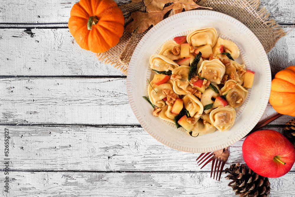 Sticker autumn pumpkin and apple tortellini pasta with walnuts and brown butter sage sauce. above view table - Stickers