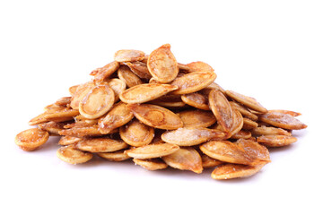 Autumn pumpkins seeds, salted and roasted in a pile isolated on a white background. Halloween treat.