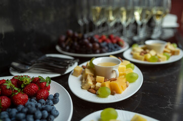 plate with cheese assortment with honey and nuts