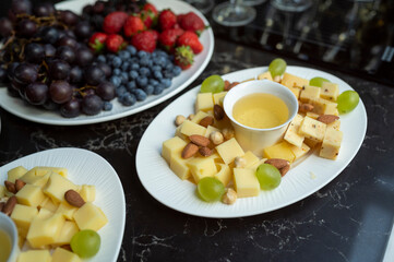 plate with cheese assortment with honey and nuts