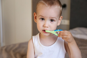 child and brushing teeth. Two years old, the child himself brushes his teeth with a toothbrush