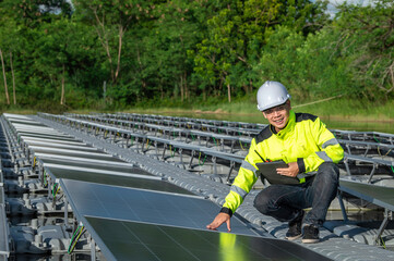 Asian engineer working at Floating solar farm,Renewable energy,Technician and investor solar panels checking the panels at solar energy installation