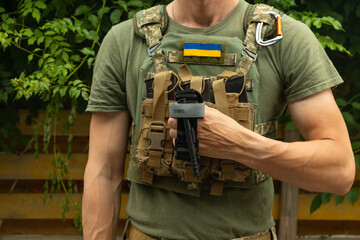 A military man holds a medical tourniquet in his hands to stop blood in first aid and prevent...