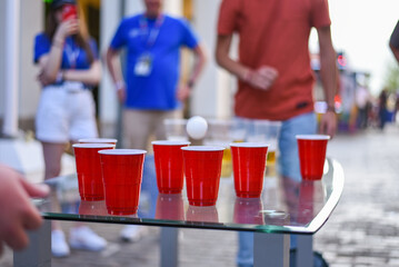 People playing Beer Pong on table at bar