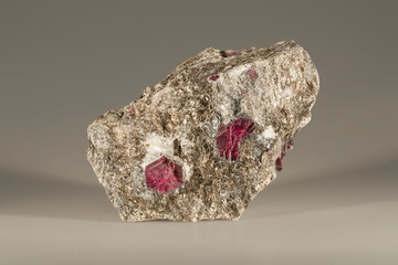 A sample of a natural mineral red Corundum (oxide class) crystalline α -aluminum oxide, crystals with albite rim in micite. Museum Mineral Series. Mineralogical sample