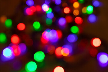 Abstract background with colorful sparkling bokeh on a dark background. Holiday concept
