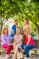 Fototapeta premium Hispanic mature senior group of friends happy together outdoors in a park. lifestyle insurance
