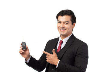 Portrait of a confident business man in black suit feeling happy and smile holding the keys of the car isolated on white background.