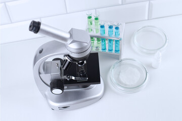 Optical microscope with three objective lenses, laboratory supplies, education concept, biology lesson, chemical research