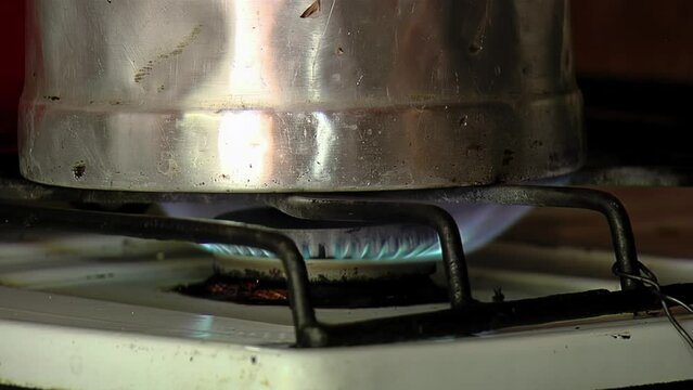 A Man Heating Water In Old Teapot Inside an Old Fashioned Kitchen. Close Up.