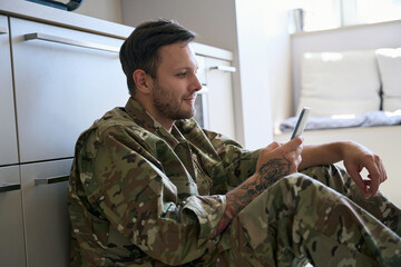 Soldier in a good mood in the rest room