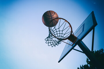 Ball enters the basket in an outdoor playing field