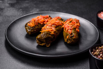 Dolma, stuffed grape leaves with rice and meat on a dark background