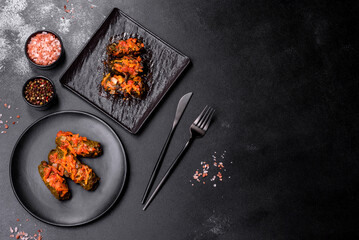 Dolma, stuffed grape leaves with rice and meat on a dark background