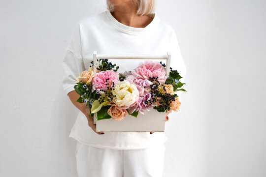 beautiful bouquet of flowers in  hands of awoman. photo for  postcard and catalog of an online flower shop. fresh flower delivery