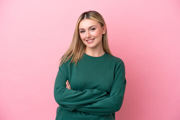 Young caucasian woman isolated on pink background keeping the arms crossed in frontal position