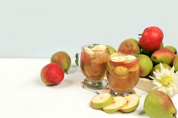 Apple and pear cider, juice or fruit drink and ingredients on a sunny table. The concept of diet...