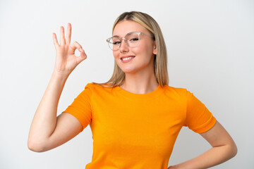 Young caucasian woman isolated on white background With glasses and doing OK sign