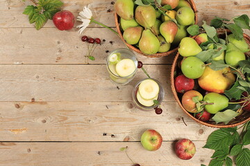 Apple and pear cider, juice or fruit drink and ingredients on a sunny table. The concept of diet...