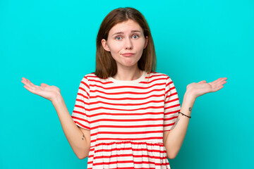 Young English woman isolated on blue background having doubts while raising hands