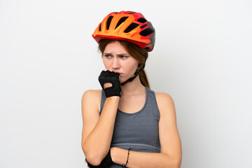 Young cyclist English woman isolated on white background having doubts