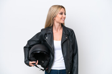 Fototapeta na wymiar Pretty blonde woman with a motorcycle helmet isolated on white background looking side