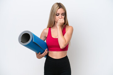 Young sport blonde woman going to yoga classes while holding a mat isolated on white background having doubts