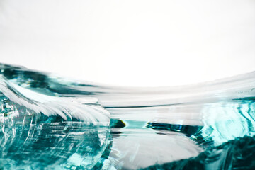 Texture of transparent blue glass on a light background.