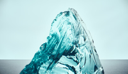 Texture of transparent blue glass on a light background.