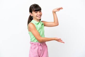 Little caucasian kid isolated on white background holding copyspace to insert an ad