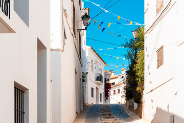 Fototapeta na wymiar Nice street in white Mediterranean-style houses in Altea la Vella, Alicante (Spain).