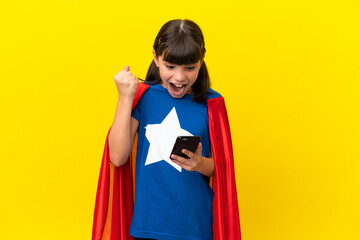 Little super hero kid isolated on purple background surprised and sending a message