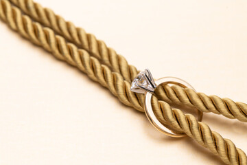Gold Engagement Diamond Ring on Ropes With Knot