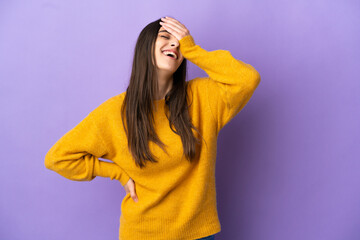 Young caucasian woman isolated on purple background smiling a lot