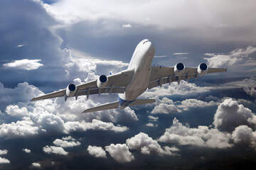 Front view of aircraft in flight. The passenger plane flies high above the clouds.