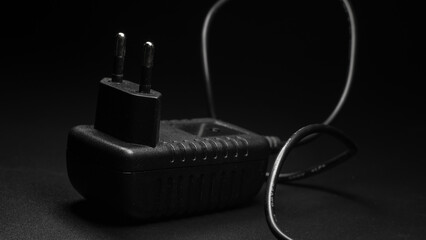 ac/dc adapter on black background
