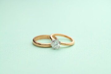 Gold Engagement Diamond Ring on Turquoise Background