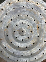 A round galvanized sheet metal with small holes