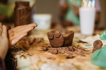 children's hands sculpts clay crafts pottery school