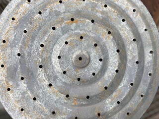 A round galvanized sheet metal with small holes