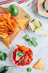 Salsa sauce and nacho chips on gray marble background. Mexican salsa sauce