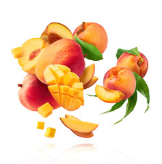 Fresh ripe whole and sliced mango and peaches with green leaves falling in the air