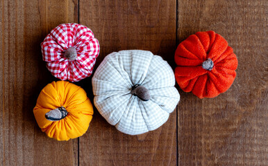 Small pumpkins made of cloth on wooden boards. Autumn, harvest and Halloween concept.