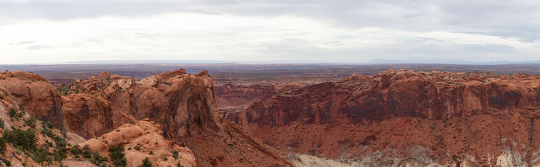 Fototapeta na wymiar Scenic Panoramic View of American Landscape and Red Rock Mountains in Desert Canyon. Colorful Sky. Canyonlands National Park. Utah, United States. Nature Background Panorama