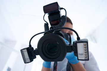 Professional dentist taking dental photos with digital camera