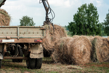 Machine unloads a haystack. Preparing for winter on the farm.