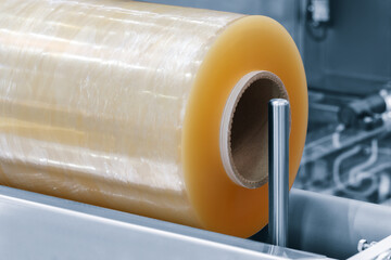 Automatic polyethylene plastic bag production machine with lighting effect. Close-up of the roller...