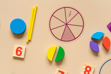 Wooden toy blocks. School supplies, math fractions, pencils, numbers, on beige background. Back to school, education concept background	