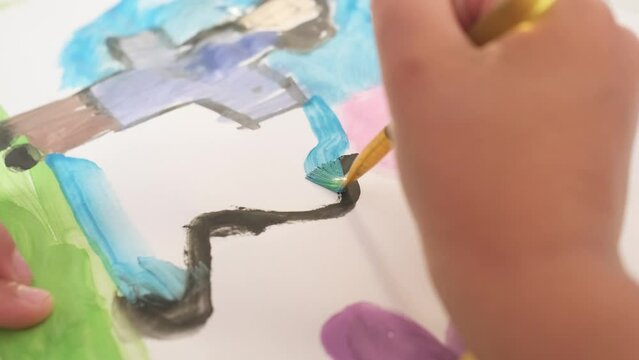 Close up Talented little girl Female Artist Draws Mother Sun Summer Flover drawing at Home. Colorful, Emotional Happy painting with Brush water colors. Contemporary Painter Creating Abstract Modern