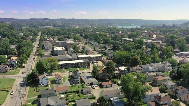 A slow forward motion summer establishing shot of Beaver, Pennsylvania, an upscale river town north of Pittsburgh. Ohio River in the distance.  	